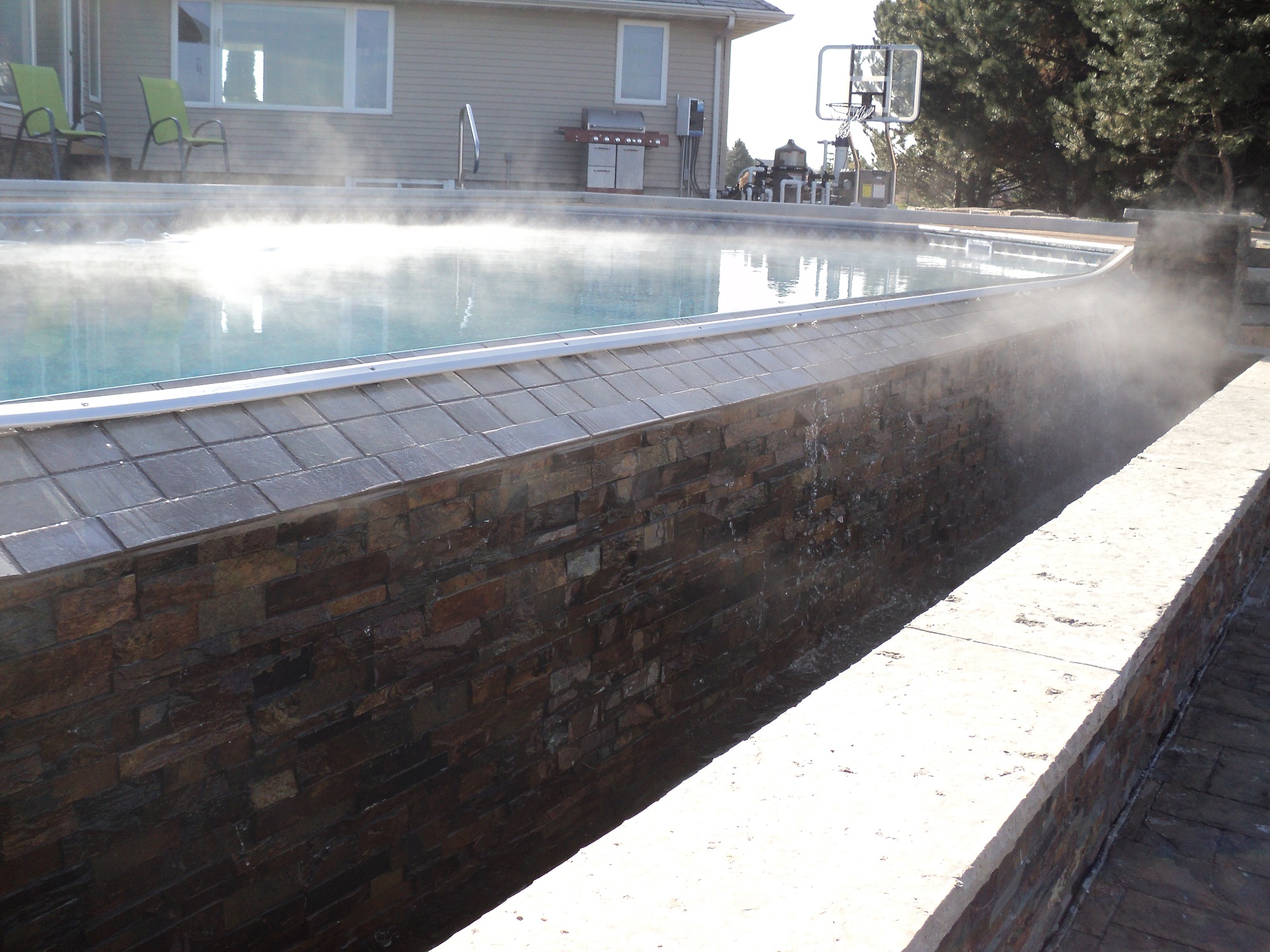 Vanishing edge in-ground pool installed by Spring's Pools and Spas